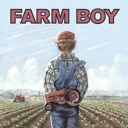 A child holding a toy tractor in a farm

Description automatically generated